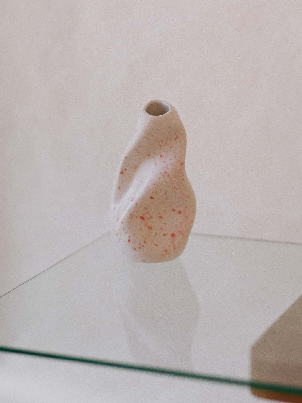 sculpted small ceramic vase with pink splashes 