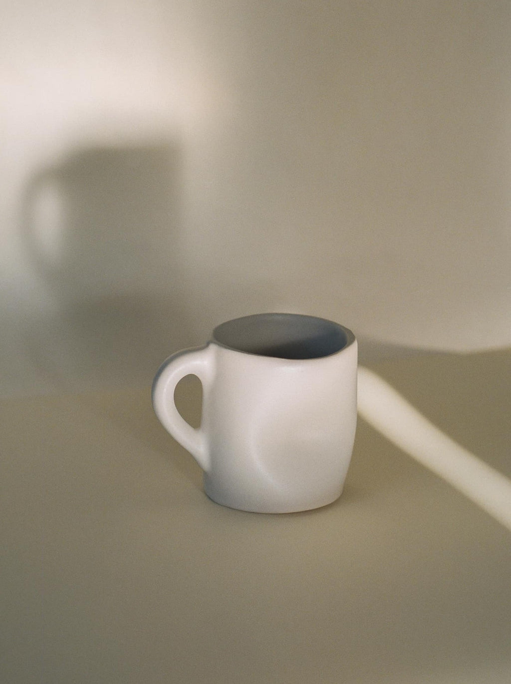 sculpted white ceramic mug